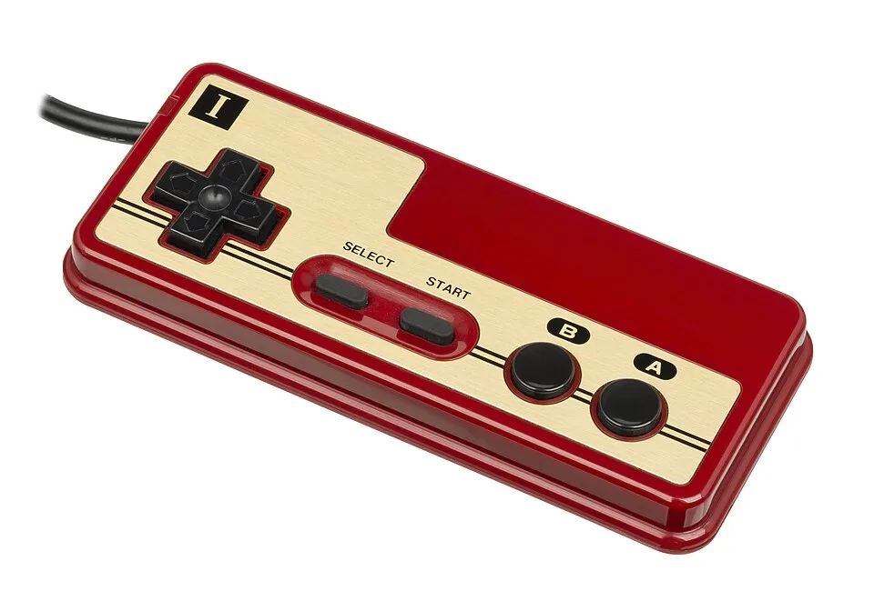 A red and gold Famicom controller, with a black cross-shaped direction button and two round buttons marked B and A.